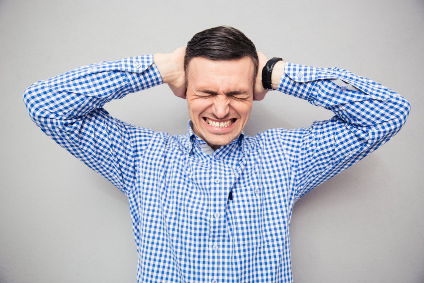 Man covering his ears